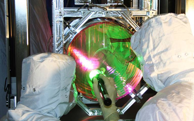 Technicians inspecting a LIGO mirror
