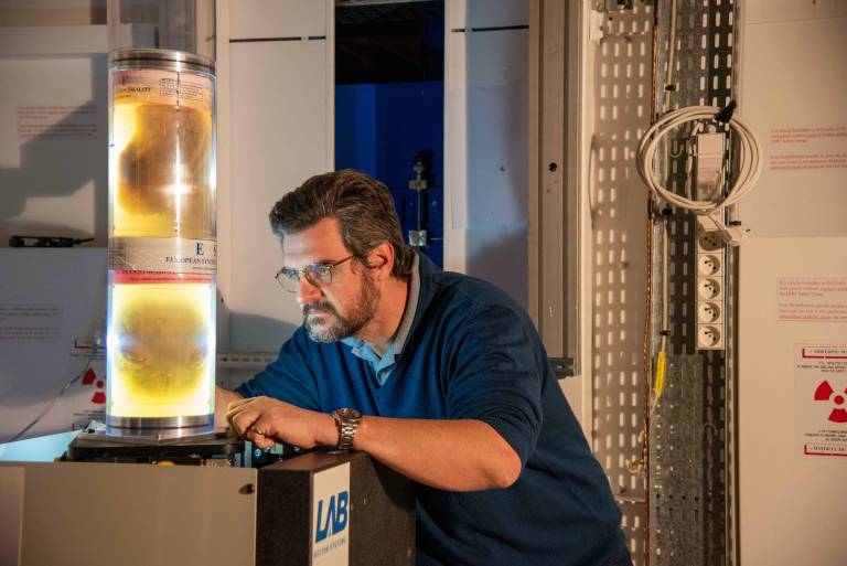 Professor Paul Taffreau Looking into a tube containing a human organ 