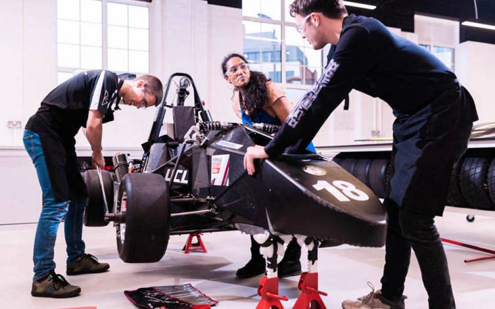 three students building a racing car