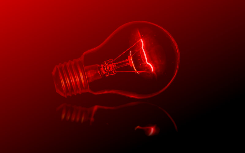 Light bulb bathed in red light