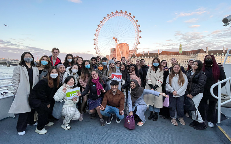 students posing for a picture in front of the London Eye