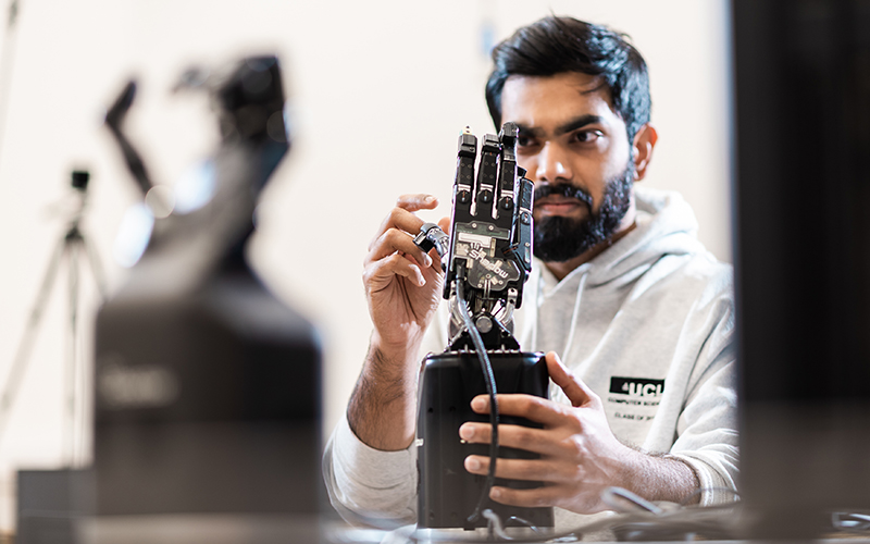 Researcher working on a robotic hand