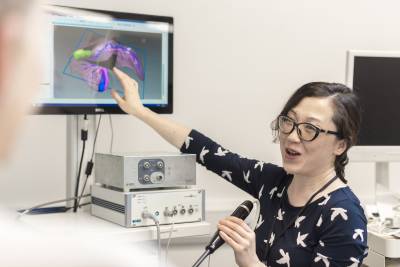female researcher shows 3D model of liver on screen