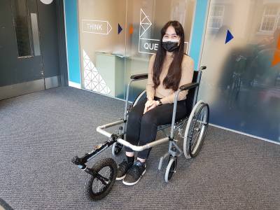 Student sitting in a prototype wheelchair