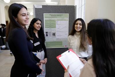 Students standing with their research poster