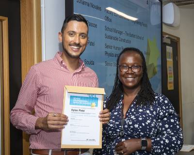 a picture of a man holding a certificate next to a woman