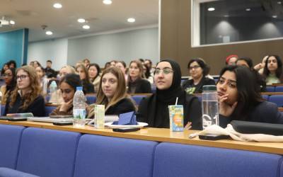A lecture theatre full of female students watching a lecture