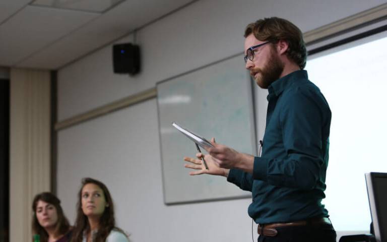 A lecturer teaching in a seminar room