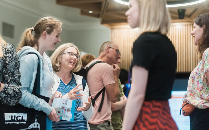Open day visitors at UCL speak to staff across a desk