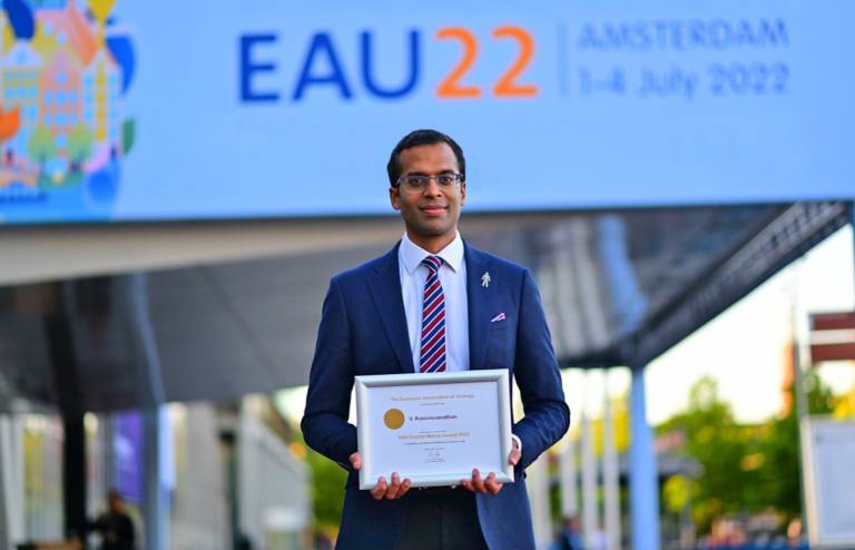 Dr Veeru Kasivisvanathan holding Crytal Matula award outside EAU congress 2022 in Amsterdam 