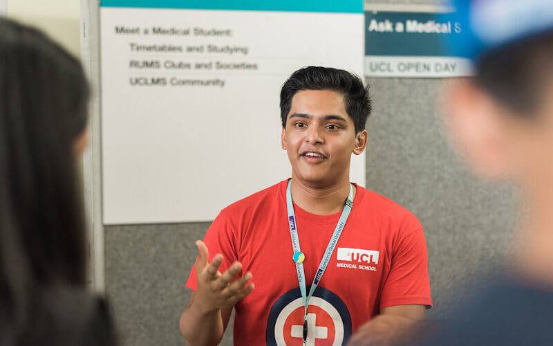 A UCL medical school student chats to visitors at an Open Day