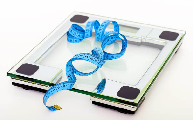 A weighing scale and tape measure