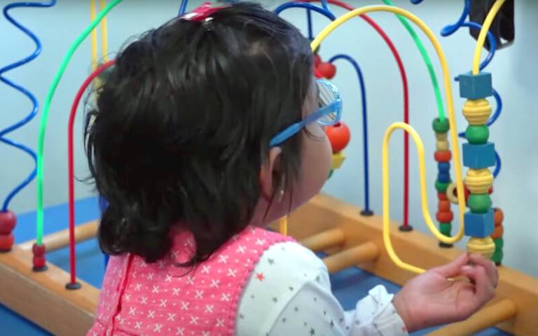 Eight-year-old Aditi Shankar playing with a toy in hospital