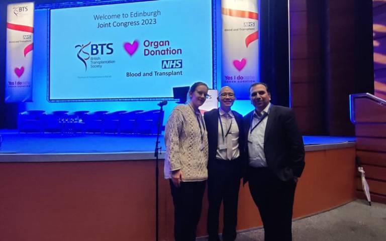 Professor Reza Motallebzadeh and group members below the stage at the Edinburgh Joint Congress 2023
