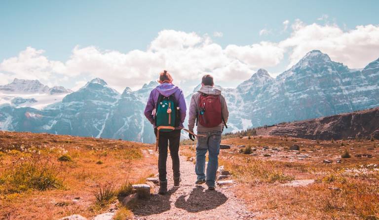 Photo of walkers in Banff National Park Canada by Jaime Reimer from Pexels: https://www.pexels.com/photo/two-person-walking-on-unpaved-road-2679814/
