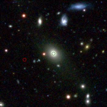 Central 2 arcsecond region of the cluster Abell 1411, one of the rich clusters present in the KiDS DR2 area. This color image was made from KiDS u-, g- and r-band data and shows the Brightest Cluster Galaxy, indicated by the green circle; the red circle s