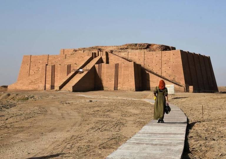 An woman walks towards the Great Ziggurat temple in Iraq