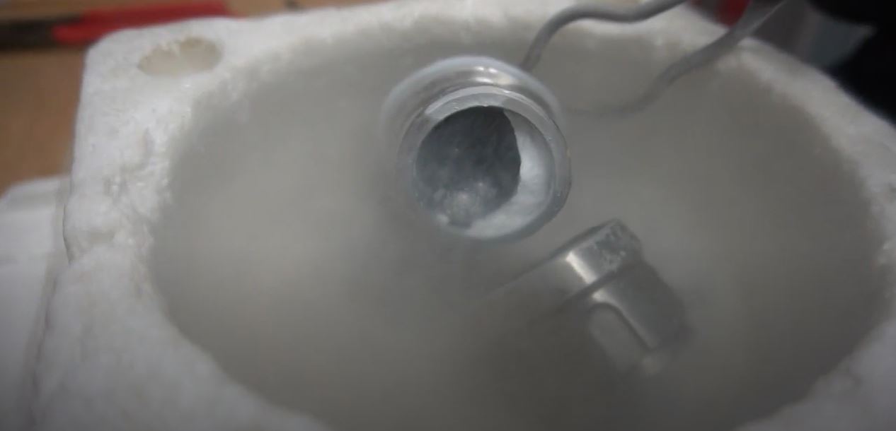 Screenshot from video showing the jar with medium-density amorphous ice inside, somewhat obscured by liquid nitrogen.