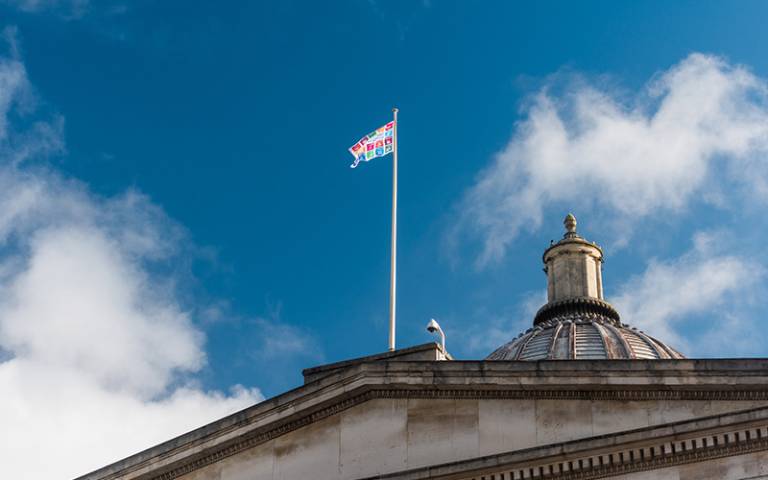 UN SDG flag on top of UCL Portico
