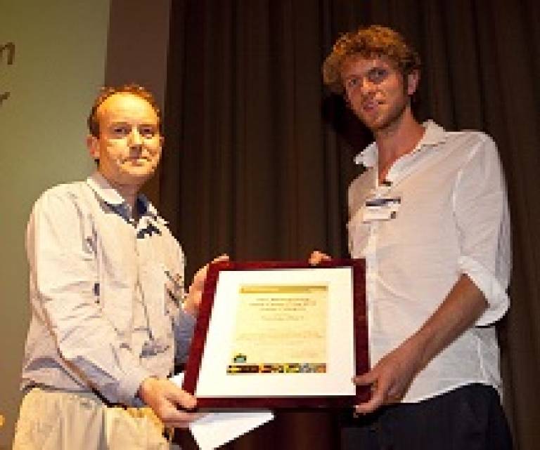 Dr Thomas Akam receiving prize from Prof Trevor Smart
