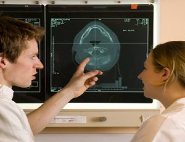 Medical staff discussing an image of a human brain