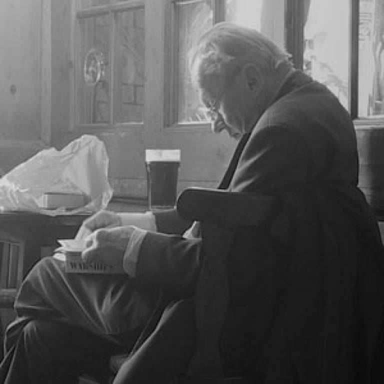Old man drinking in pub