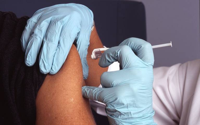 a nurse administers a vaccine