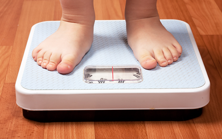 an image of a child standing on scales