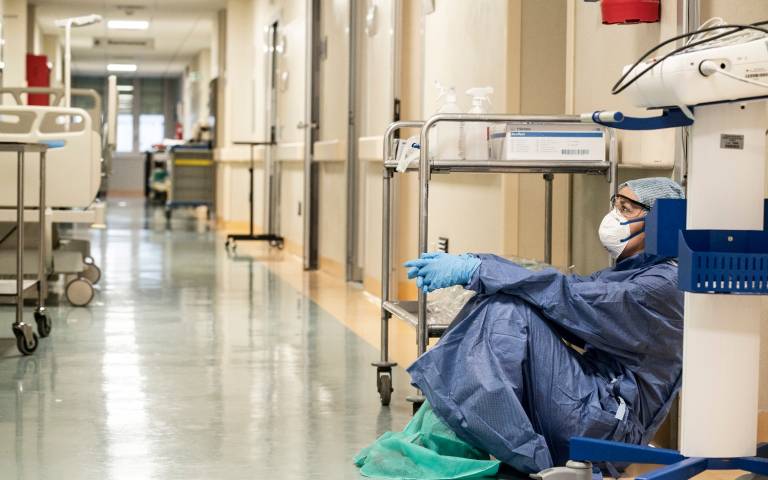 healthcare worker on a break in San Salvatore Hospital, Italy, in March 2020