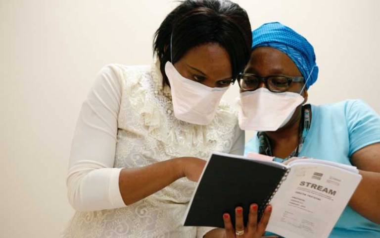 Study team members at King Dinuzulu Hospital in Durban, South Africa, review trial requirements in the STREAM protocol. 