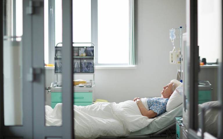 an elderly woman lying in a hospital bed
