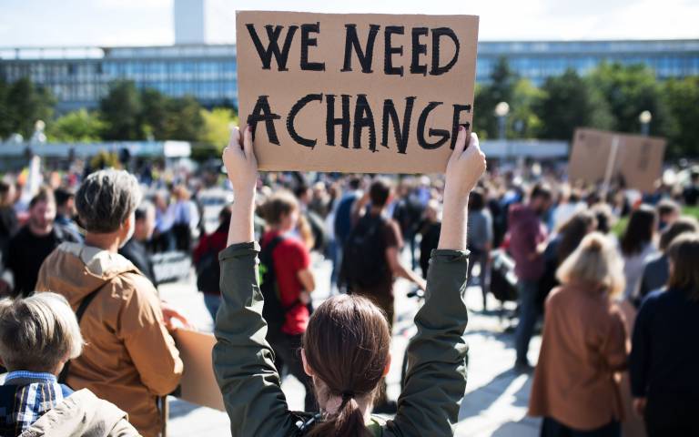A rear view of people with placards and posters on global strike for climate change. Image: iStock