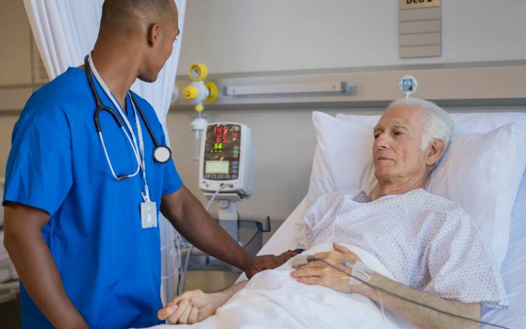 Doctor examining senior man in hospital