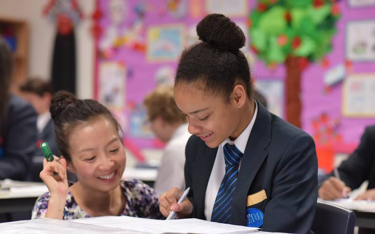 A teacher helps a student learn Mandarin. Credit: Philip Meech Photography