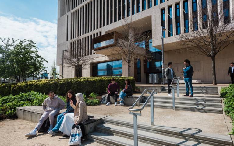 students sit outside in the sun at Marshgate campus