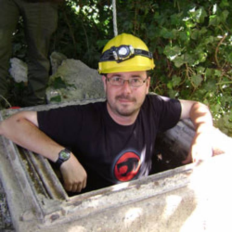 UCL archaeologist Dr Gabriel Moshenska emerging from air raid shelter