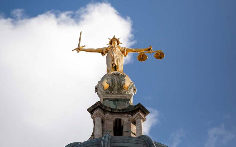 a statue of Justice on top of the Old Bailey