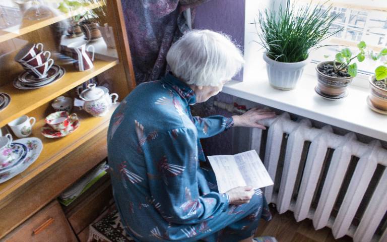 elderly woman reading a bill
