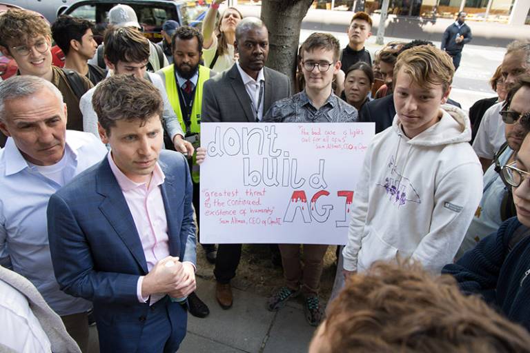 Sam Altman talks to students protesting outside the IOE building