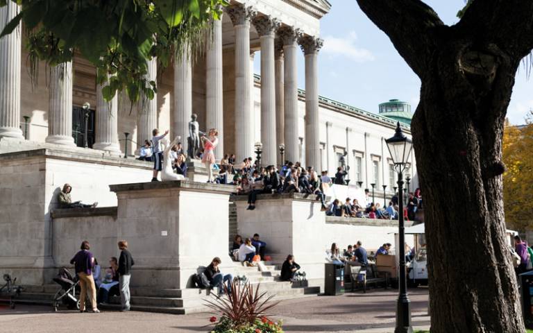 UCL's Quad with crowds of people looking at an art installation on the Portico steps