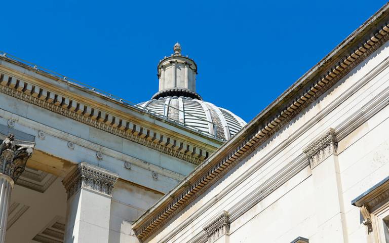 A view of the Wilkins Building and Portico, with blue sky