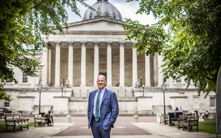 UCL Provost Dr Michael Spence standing in front of the UCL Portico