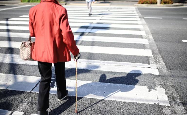 Older person crossing a road