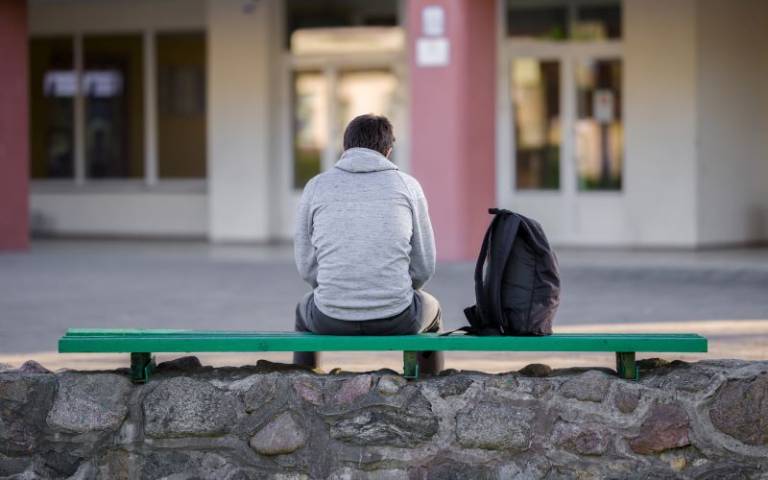Sad teenager on bench
