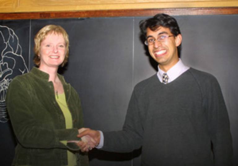 Dr Arjun Sen receiving first prize for his poster