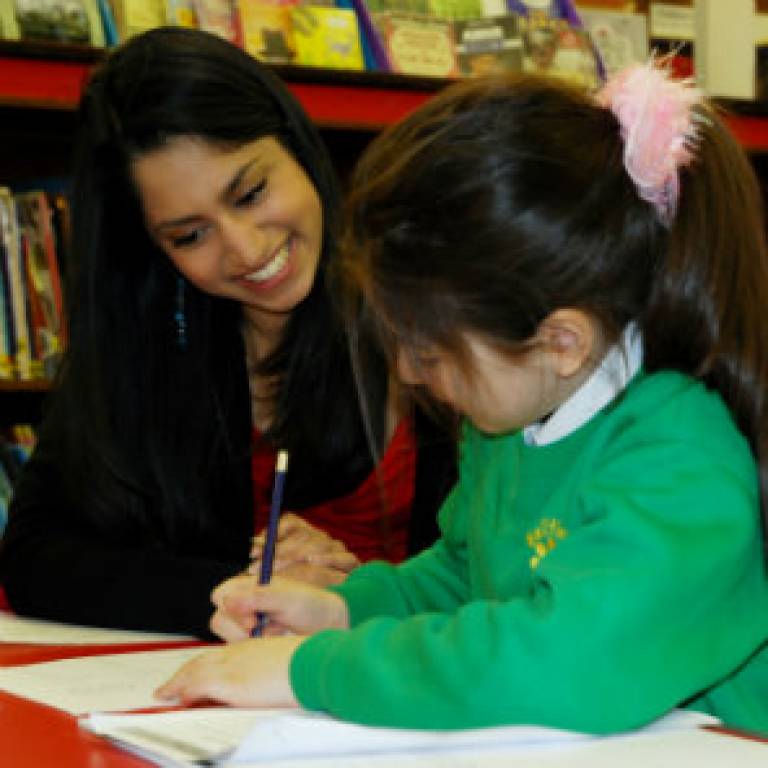 UCL student Kimberley De Souza helping with the homework during the Summer Reading Challenge