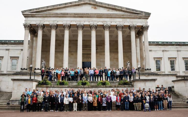 a group photo of UCL's technical staff in front of the portico.
