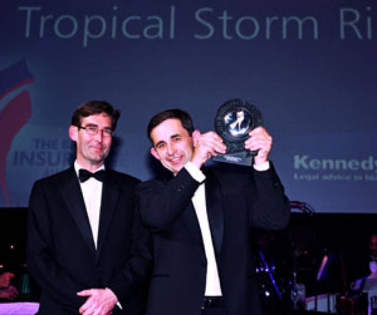 Nick Williams, left, Kennedys partner, presents Dr Mark Saunders, lead scientist of Tropical Storm Risk with the London Market Innovation of the Year award at the Royal Albert Hall, London, in front of an audience of 1,800