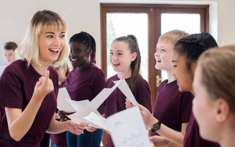 teacher encourages choir