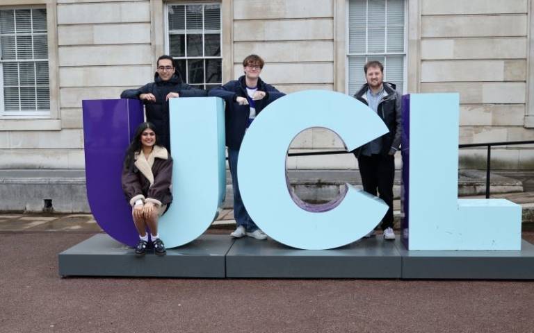 The University Challenge finalists sitting on UCL letters on Campus. 